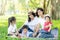 Beautiful young asian parent family portrait picnic in the park, kid or children and mother love happy and cheerful together