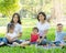 Beautiful young asian parent family portrait picnic in the park, kid or children and mother love happy and cheerful together
