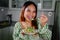 beautiful young asian woman eating healthy mediterranean food. smiling happy girl eating greek salad
