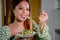 beautiful young asian woman eating healthy mediterranean food. smiling happy girl eating greek salad