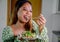 beautiful young asian woman eating healthy mediterranean food. smiling happy girl eating greek salad