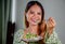 beautiful young asian woman eating healthy mediterranean food. smiling happy girl eating greek salad