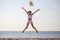 beautiful  young asian woman  excited throwing hats up on the air  at the sea beach . Happy girl enjoy  holidays vacation .