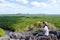 A beautiful young asian woman sitting on the mountain peak while traveling the mangrove forest viewpoint