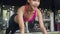 Beautiful young athlete Asian lady exercise doing push-ups fat burning workout in fitness class. Sportswoman recreational activity