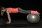 Beautiful young athletic woman exercising with a gymnastics ball