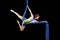 Beautiful young, athletic woman professional aerial circus artist with redhead in yellow costume posing diagonal in the air,