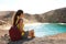 Beautiful young backpacker admiring Playa Papagayo beach in Lanzarote, Canary Islands, Spain