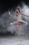 Beautiful young ballerina dancing in white flour