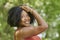 Beautiful young black woman poses in orange tank top