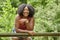 Beautiful young black woman poses in orange tank top and denim skirt