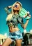 Beautiful young blond model girl in summer hipster clothes with skateboard