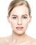 Beautiful Young Blond Woman with Face cream applied under her eyes. Facial treatment. Beauty and spa concept.