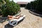 Beautiful young blond woman lying on sunbed in country house area