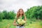 A beautiful young blonde girl collected a bouquet of wildflowers. Enjoy a walk on a warm summer day