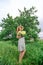 A beautiful young blonde girl collected a bouquet of wildflowers. Enjoy a walk on a warm summer day