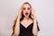 Beautiful young blonde girl with surprised face, young woman with opened mouth. Studio shot. Wearing pink cool glasses