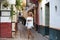 Beautiful young blonde girl from USA sightseeing in Seville, Spain. The girl dressed in a short white skirt and white top strolls