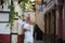Beautiful young blonde girl from USA sightseeing in Seville, Spain. The girl dressed in a short white skirt and white top strolls
