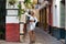 Beautiful young blonde girl from USA sightseeing in Seville, Spain. The girl dressed in a short white skirt and white top strolls