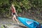 Beautiful young blonde woman kayaking on lake