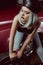 beautiful young blonde woman in leather beret repairing car