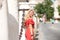 Beautiful young blonde woman from the United States is on a sightseeing trip in Seville, Spain. The girl leans between the columns