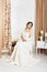 Beautiful young bride in crochet shawl and dress