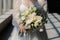 Beautiful young bride holding a stunning bouquet of white and green flowers