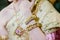 beautiful young bride lay hands on lap wear gold bracelets on her wrist and wedding diamond ring,