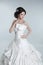 Beautiful young bride woman posing in wedding dress isolated on