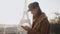 Beautiful young brunette blogger woman typing message on phone at sunrise Paris Eiffel Tower city scenery slow motion.