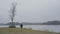 Beautiful young brunette caucasian fitness woman running outdoor in Swedish winter landscape close ice lake