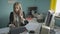 Beautiful young business woman talking on phone in office stock footage video