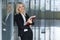 Beautiful young businesswoman smiling and standing with folder in the office. looking at camera. copy space.