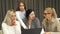 Beautiful young businesswoman using laptop during business meeting with colleagues