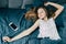 A beautiful young Caucasian teenage girl with long hair is lying next to the phone stretching in bed and has not yet woken up. Tee