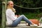 Beautiful young contemplative woman sitting staring at nature