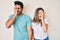 Beautiful young couple of boyfriend and girlfriend together yawning tired covering half face, eye and mouth with hand