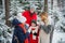 A beautiful young couple with children walks through a fabulous winter forest during the new year or Christmas holidays