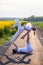 Beautiful young couple doing acro yoga on the bike path. Man lying on road and balancing woman in his feet