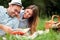 Beautiful young couple having a relaxing romantic picnic in a park