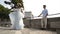 Beautiful young couple on honeymoon. Action. Husband admires his beautiful young wife whirling in white dress. Newlyweds