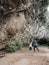 Beautiful young couple jumping in the air of happiness in front of a cave