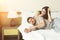 Beautiful young couple lying on bed in hotel