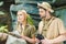 beautiful young couple in safari suits with parrot trying to navigate