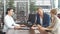 Beautiful young couple signs documents at dealership showroom