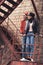 beautiful young couple standing on old rusty stairs