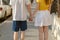 Beautiful Young couple walk hand in hand on the road
