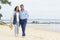 Beautiful young couple walking on shore